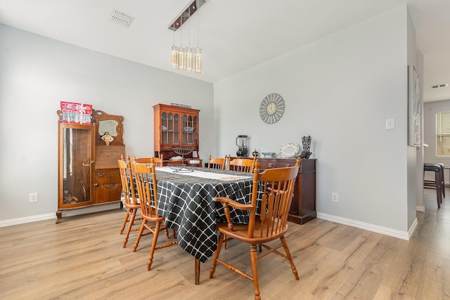 2344 Magnolia Dr, Little Elm, TX 75068 - dining space featuring wood finished floors, baseboards, and a bar