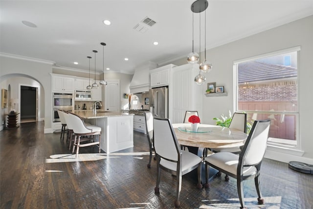 415 Fountainview Dr, Irving, TX 75039 - dining room with ornamental molding, arched walkways, dark wood-type flooring, and recessed lighting