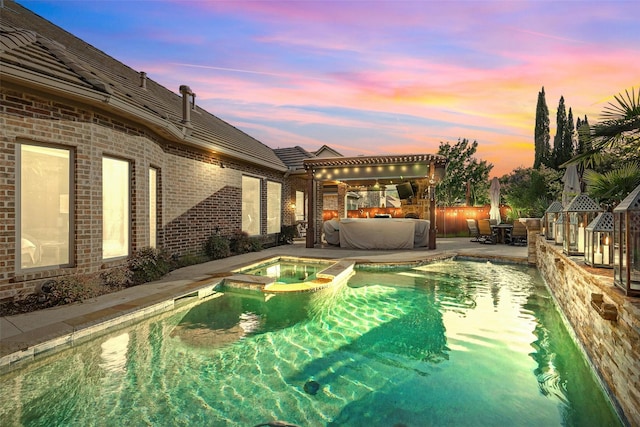 415 Fountainview Dr, Irving, TX 75039 - pool at dusk with a patio area and a pool with connected hot tub