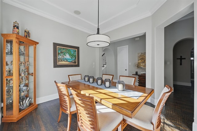 415 Fountainview Dr, Irving, TX 75039 - dining space with arched walkways, dark wood finished floors, baseboards, crown molding, and a raised ceiling