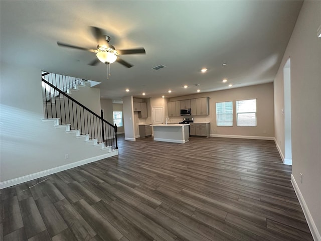 123 Monarch Way, Wylie, TX 75098 - unfurnished living room featuring dark wood-style flooring, baseboards, ceiling fan, recessed lighting, and stairs