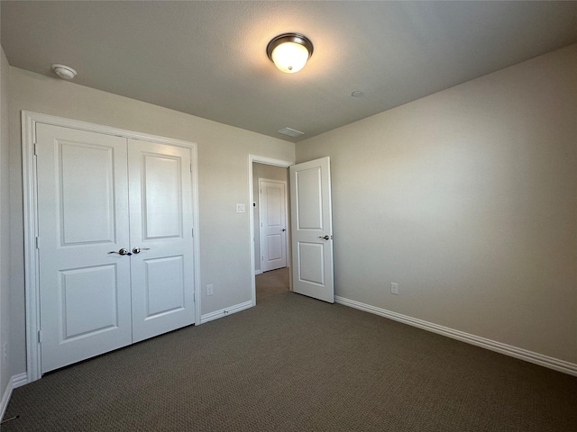 123 Monarch Way, Wylie, TX 75098 - unfurnished bedroom featuring dark carpet, baseboards, and a closet