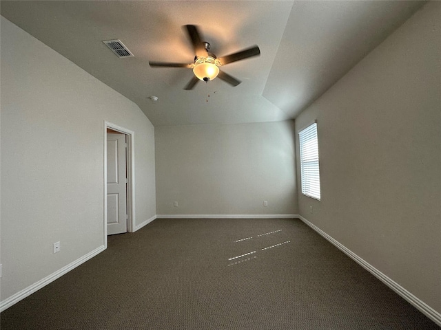 123 Monarch Way, Wylie, TX 75098 - empty room featuring a ceiling fan, vaulted ceiling, dark colored carpet, and baseboards