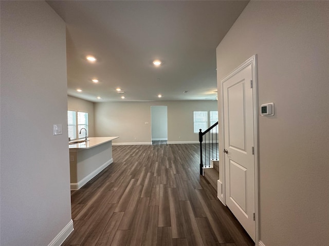 123 Monarch Way, Wylie, TX 75098 - hallway featuring baseboards, dark wood-style floors, recessed lighting, a sink, and stairway