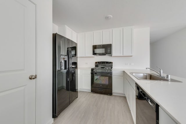 1937 Kiwi Dr, Royse City, TX 75189 - kitchen featuring black appliances, a sink, light wood-type flooring, and light countertops