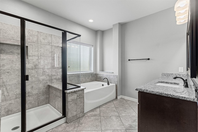 1028 Morningside Dr, Burleson, TX 76028 - bathroom featuring a bath, a shower stall, double vanity, tile patterned flooring, and baseboards