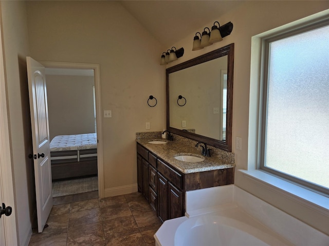 632 Yucca Ct, Aledo, TX 76008 - ensuite bathroom with double vanity, vaulted ceiling, a garden tub, and baseboards