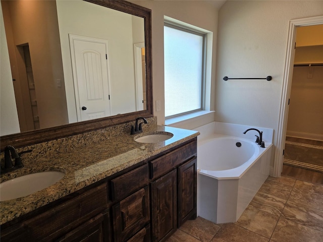 632 Yucca Ct, Aledo, TX 76008 - bathroom featuring double vanity, a bath, and a walk in closet