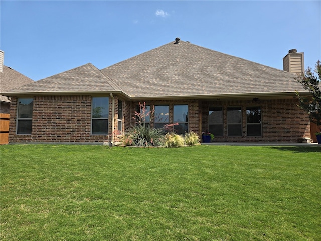 632 Yucca Ct, Aledo, TX 76008 - rear view of house with a chimney, brick siding, a lawn, and roof with shingles