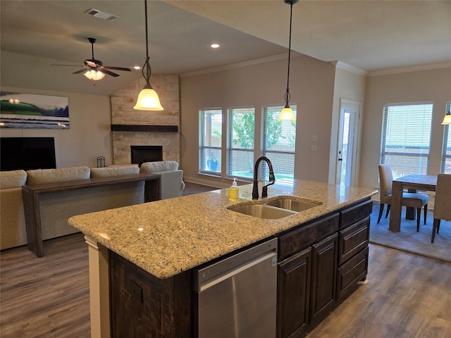 632 Yucca Ct, Aledo, TX 76008 - kitchen featuring a sink, dishwasher, dark wood-style flooring, ornamental molding, and a stone fireplace