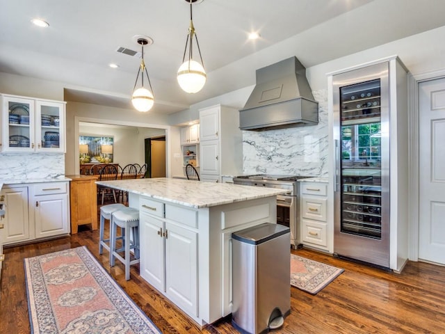 104 Crestwood Dr, Fort Worth, TX 76107 - kitchen with premium range hood, high end stove, a center island, wine cooler, and decorative backsplash