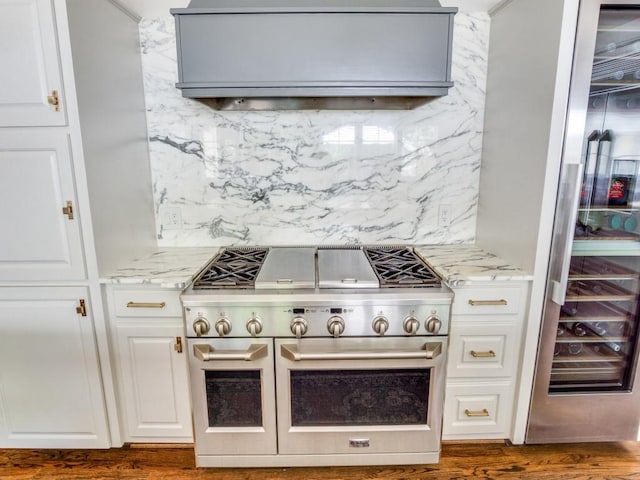 104 Crestwood Dr, Fort Worth, TX 76107 - kitchen featuring double oven range, decorative backsplash, light stone countertops, white cabinets, and dark wood finished floors