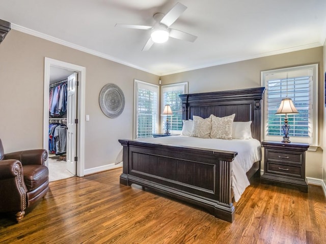 104 Crestwood Dr, Fort Worth, TX 76107 - bedroom featuring wood finished floors, a spacious closet, baseboards, and crown molding