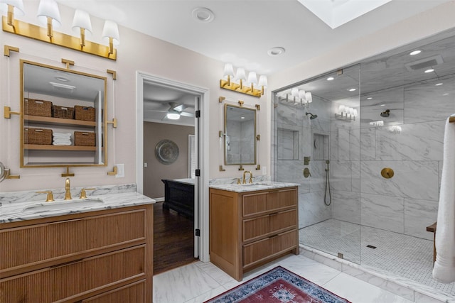 104 Crestwood Dr, Fort Worth, TX 76107 - full bathroom featuring marble finish floors, two vanities, a stall shower, and a ceiling fan