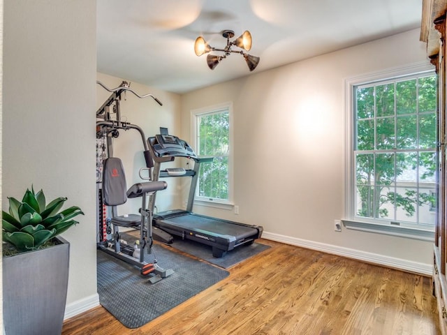 104 Crestwood Dr, Fort Worth, TX 76107 - exercise room with wood finished floors, plenty of natural light, a chandelier, and baseboards