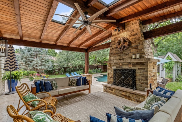 104 Crestwood Dr, Fort Worth, TX 76107 - fenced backyard with an outdoor living space with a fireplace, ceiling fan, and a patio area