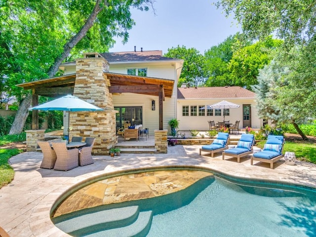104 Crestwood Dr, Fort Worth, TX 76107 - back of house featuring outdoor dining space, a patio area, and an outdoor pool