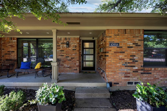 10916 Ferndale Rd, Dallas, TX 75238 - doorway to property featuring a porch and brick siding