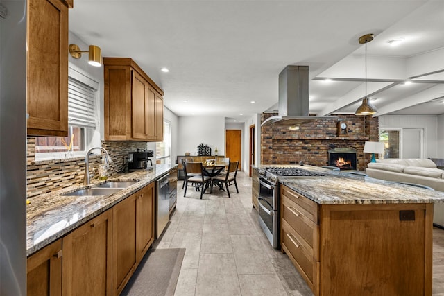 10916 Ferndale Rd, Dallas, TX 75238 - kitchen featuring appliances with stainless steel finishes, a sink, a brick fireplace, brown cabinets, and tasteful backsplash