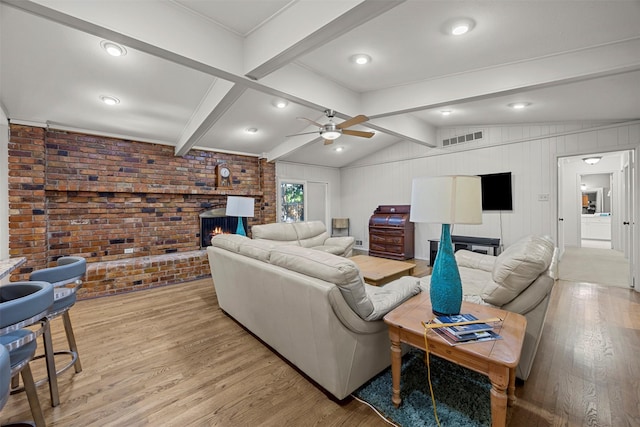 10916 Ferndale Rd, Dallas, TX 75238 - living room with brick wall, a brick fireplace, a ceiling fan, and light wood finished floors