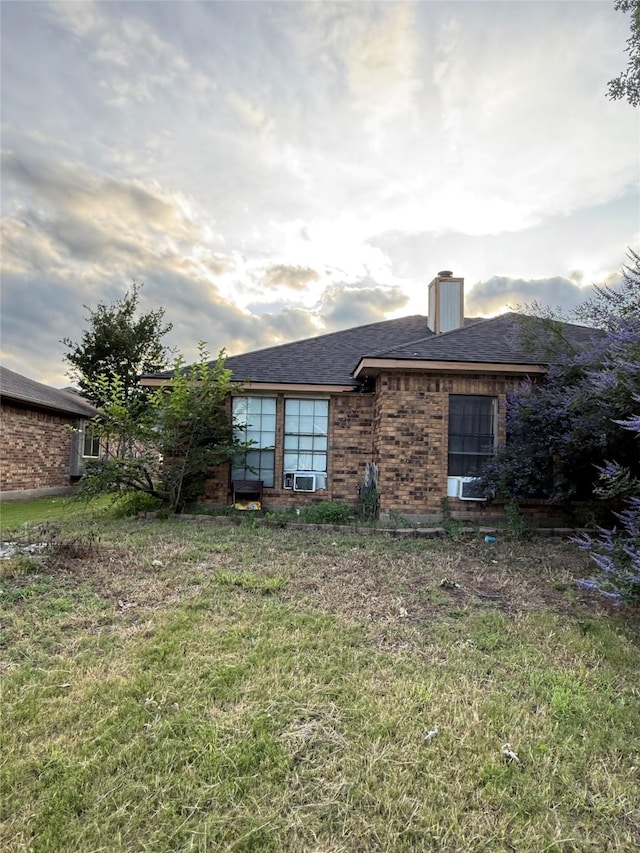 801 Micarta Dr, Mesquite, TX 75181 - rear view of property with a chimney, brick siding, a lawn, roof with shingles, and cooling unit