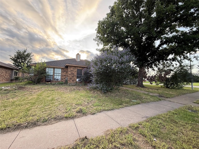 801 Micarta Dr, Mesquite, TX 75181 - view of side of property with brick siding, a chimney, and a lawn