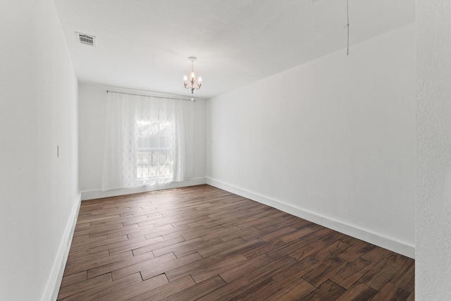 6622 Victoria Ave, Dallas, TX 75209 - spare room featuring a chandelier, dark wood-style floors, and baseboards