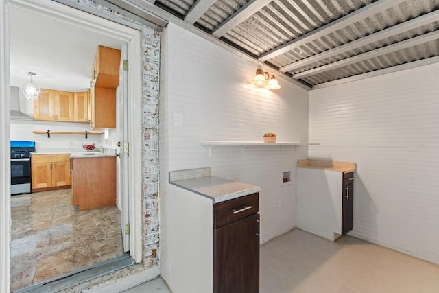 6622 Victoria Ave, Dallas, TX 75209 - kitchen with stainless steel range with gas stovetop, wall chimney range hood, light countertops, and open shelves