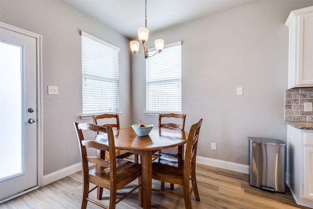 3501 Brazos St, Melissa, TX 75454 - dining space with light wood finished floors, baseboards, and a chandelier