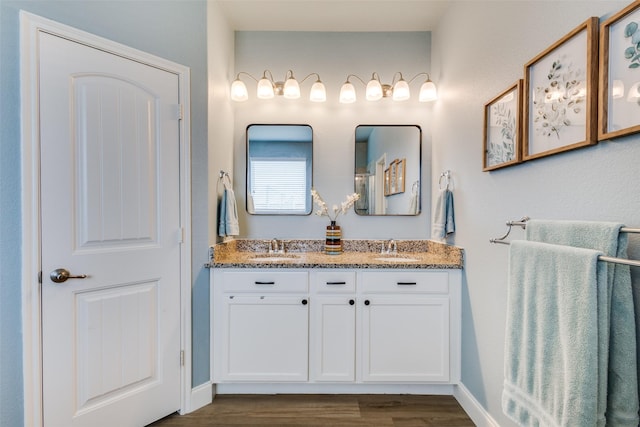 3501 Brazos St, Melissa, TX 75454 - bathroom featuring double vanity, wood finished floors, and baseboards