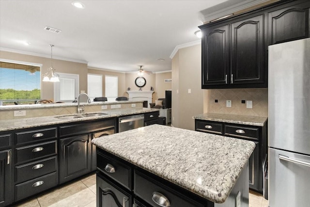 1407 Deer Hollow Dr, Arlington, TX 76002 - kitchen featuring stainless steel appliances, dark cabinetry, a sink, ornamental molding, and backsplash