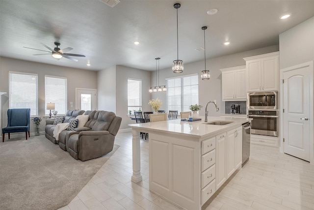 1733 Reverie Rd, Burleson, TX 76028 - kitchen featuring stainless steel appliances, a ceiling fan, open floor plan, recessed lighting, and light countertops