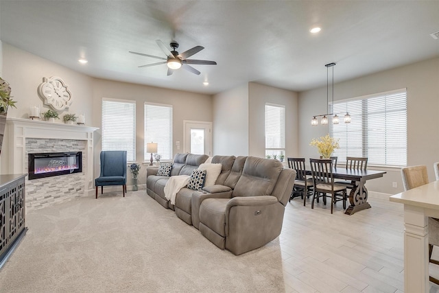1733 Reverie Rd, Burleson, TX 76028 - living room featuring a ceiling fan, healthy amount of natural light, a stone fireplace, recessed lighting, and a chandelier
