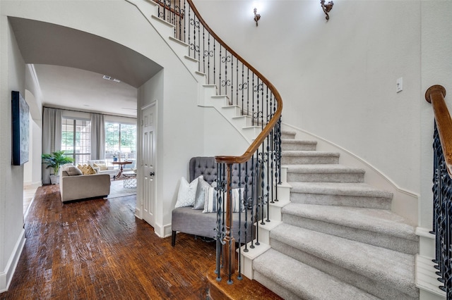 590 Willow Ridge Cir, Prosper, TX 75078 - stairs featuring wood finished floors, baseboards, and arched walkways