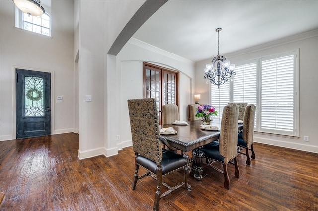 590 Willow Ridge Cir, Prosper, TX 75078 - dining area featuring arched walkways, a chandelier, baseboards, wood finished floors, and ornamental molding