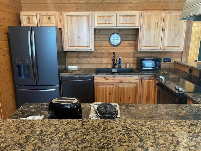 209 E Pine St, Nocona, TX 76255 - kitchen featuring black appliances, a sink, range hood, wood walls, and light brown cabinetry