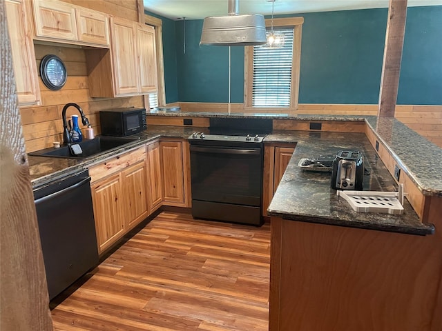 209 E Pine St, Nocona, TX 76255 - kitchen featuring black appliances, a sink, light wood-style floors, light brown cabinetry, and range hood