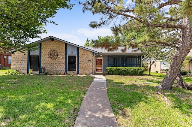1710 Goliad Dr, Garland, TX 75042 - view of front facade featuring a front yard and brick siding