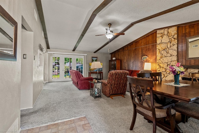 1710 Goliad Dr, Garland, TX 75042 - living area featuring wooden walls, a ceiling fan, carpet flooring, french doors, and a textured ceiling