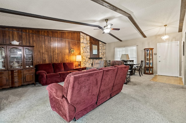 1710 Goliad Dr, Garland, TX 75042 - living area featuring carpet, a ceiling fan, wood walls, and a textured ceiling
