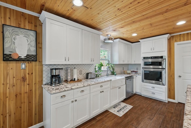 1520 Oakhurst Scenic Dr, Fort Worth, TX 76111 - kitchen with appliances with stainless steel finishes, a sink, decorative backsplash, wooden ceiling, and white cabinetry