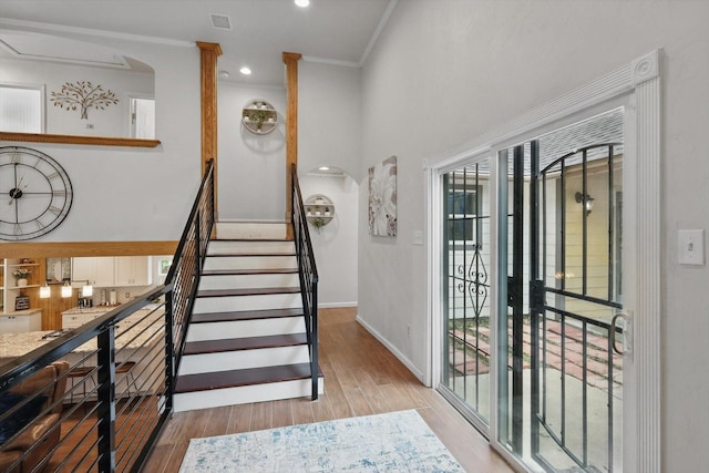 1520 Oakhurst Scenic Dr, Fort Worth, TX 76111 - foyer entrance featuring arched walkways, light wood finished floors, baseboards, a high ceiling, and stairway