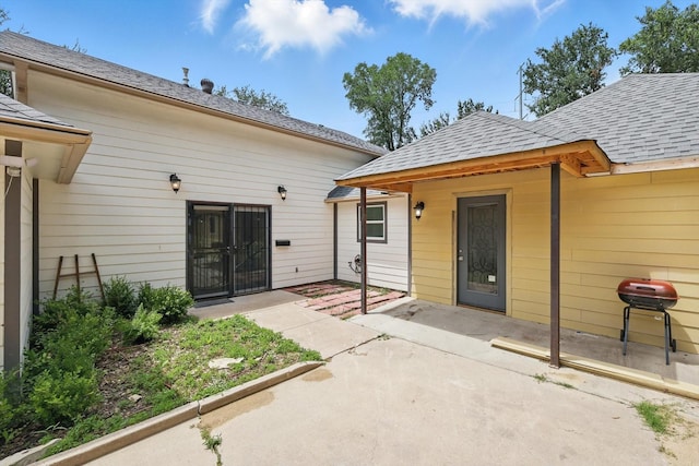 1520 Oakhurst Scenic Dr, Fort Worth, TX 76111 - doorway to property featuring a patio area and roof with shingles