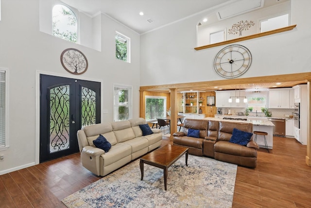 1520 Oakhurst Scenic Dr, Fort Worth, TX 76111 - living room featuring wood finished floors, ornamental molding, a towering ceiling, recessed lighting, and baseboards