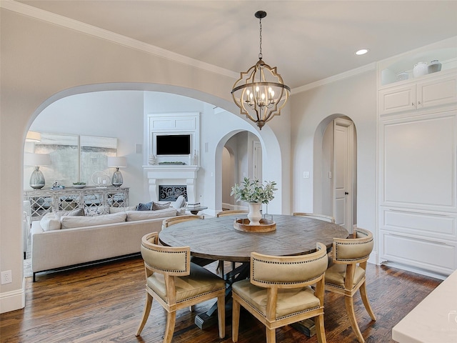 3421 Greenbrier Dr, Frisco, TX 75033 - dining room with arched walkways, ornamental molding, a chandelier, dark wood-style flooring, and a fireplace