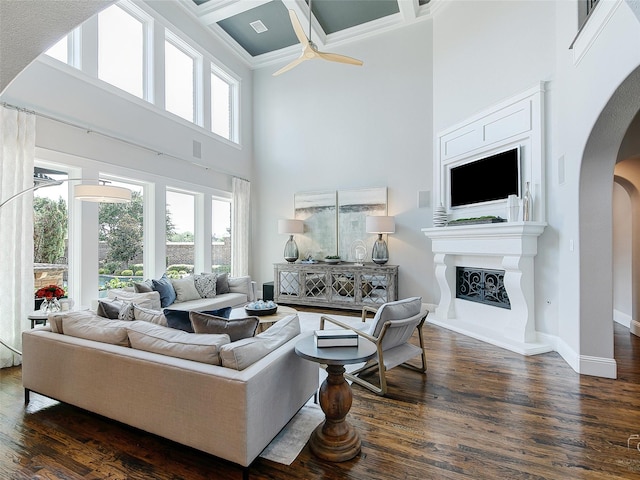 3421 Greenbrier Dr, Frisco, TX 75033 - living area with a towering ceiling, arched walkways, crown molding, dark wood-type flooring, and ceiling fan