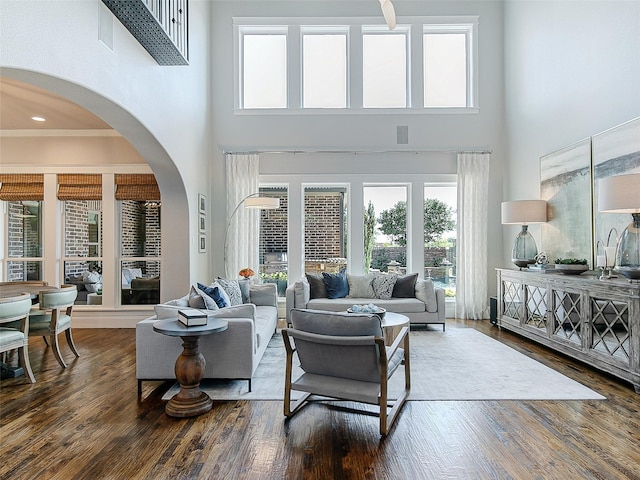 3421 Greenbrier Dr, Frisco, TX 75033 - living room with a high ceiling, wood finished floors, and arched walkways