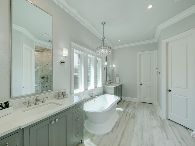 3421 Greenbrier Dr, Frisco, TX 75033 - full bath with a shower stall, two vanities, a soaking tub, crown molding, and a chandelier