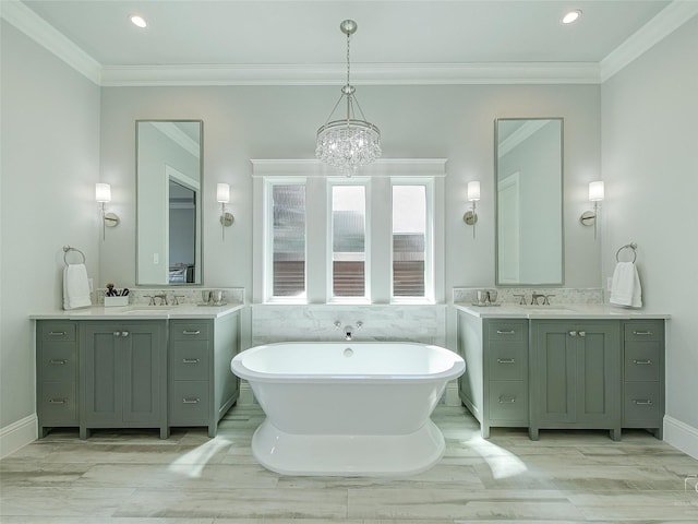 3421 Greenbrier Dr, Frisco, TX 75033 - full bathroom with a chandelier, a soaking tub, two vanities, crown molding, and recessed lighting