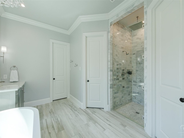 3421 Greenbrier Dr, Frisco, TX 75033 - full bath featuring a shower stall, a freestanding bath, ornamental molding, vanity, and baseboards